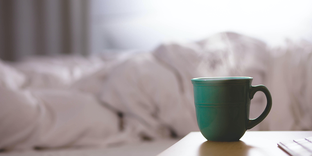 A mug of tea on a bedside table