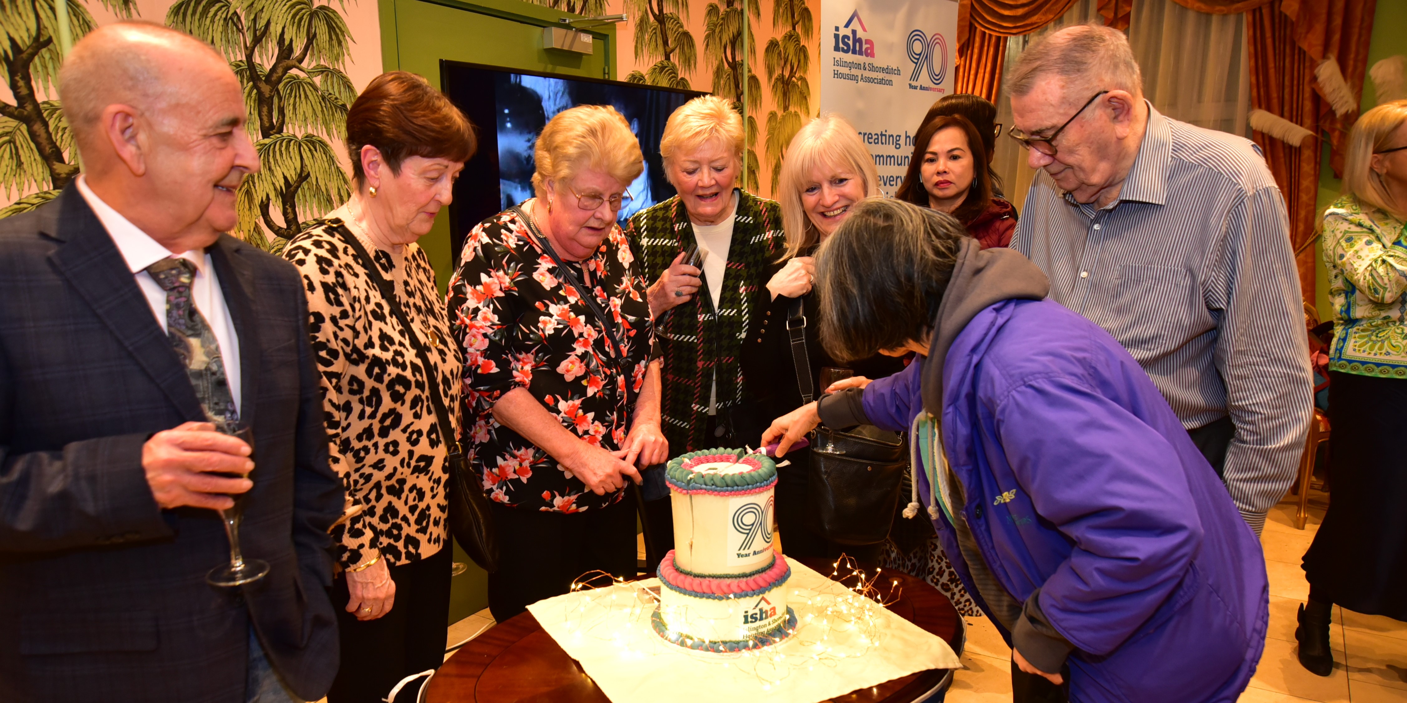 ISHA residents cutting the cake at our 90th anniversary celebrations