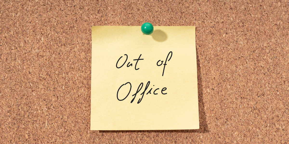 Post it note which reads, out of office