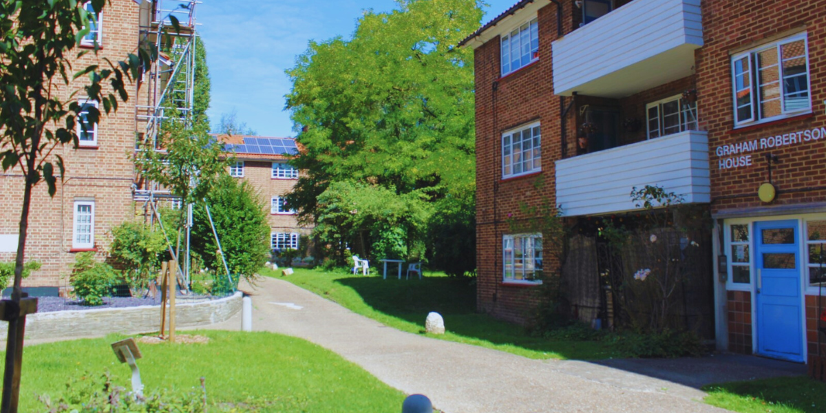 Small blocks of flats in a leafy, sunny area.