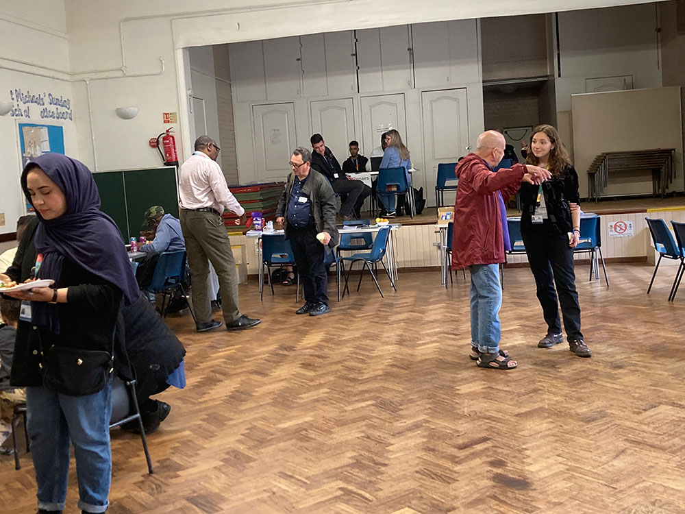 Beth talking to a resident at the Hackney meeting