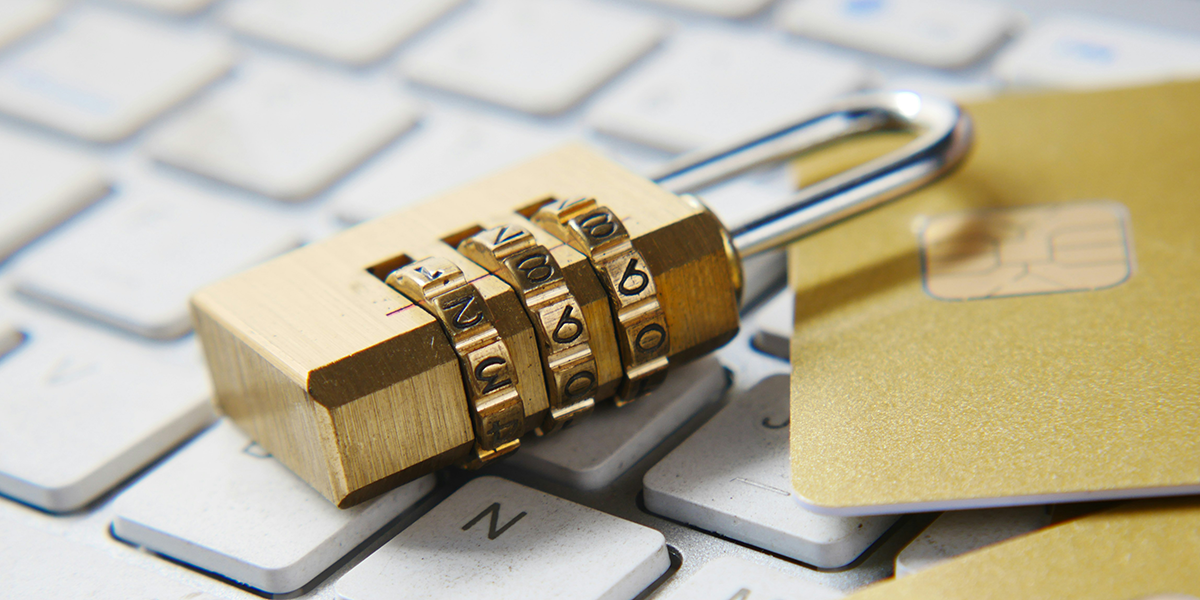 A padlock and SIM cards on top of a computer keyboard