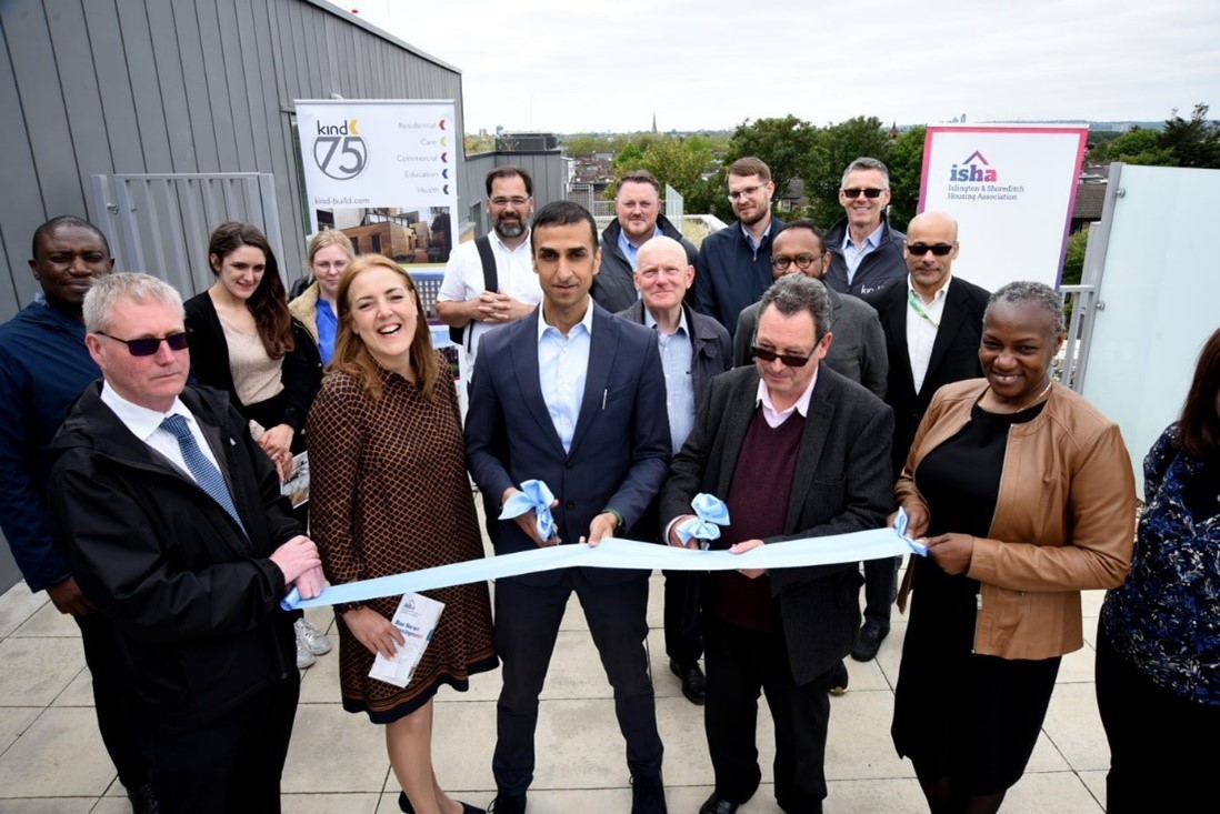 A group of people cutting a ribbon