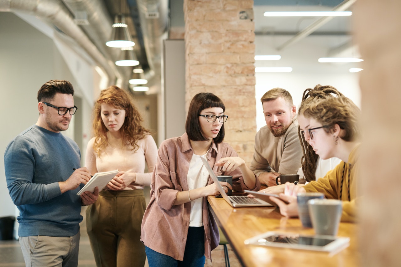 Four people having a discussion in an office