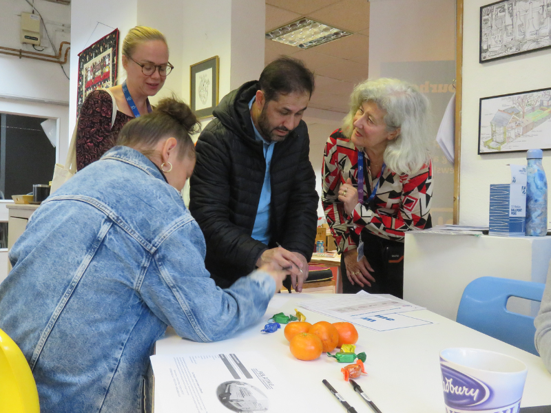 ISHA staff greet residents at a neighbourhood night. 