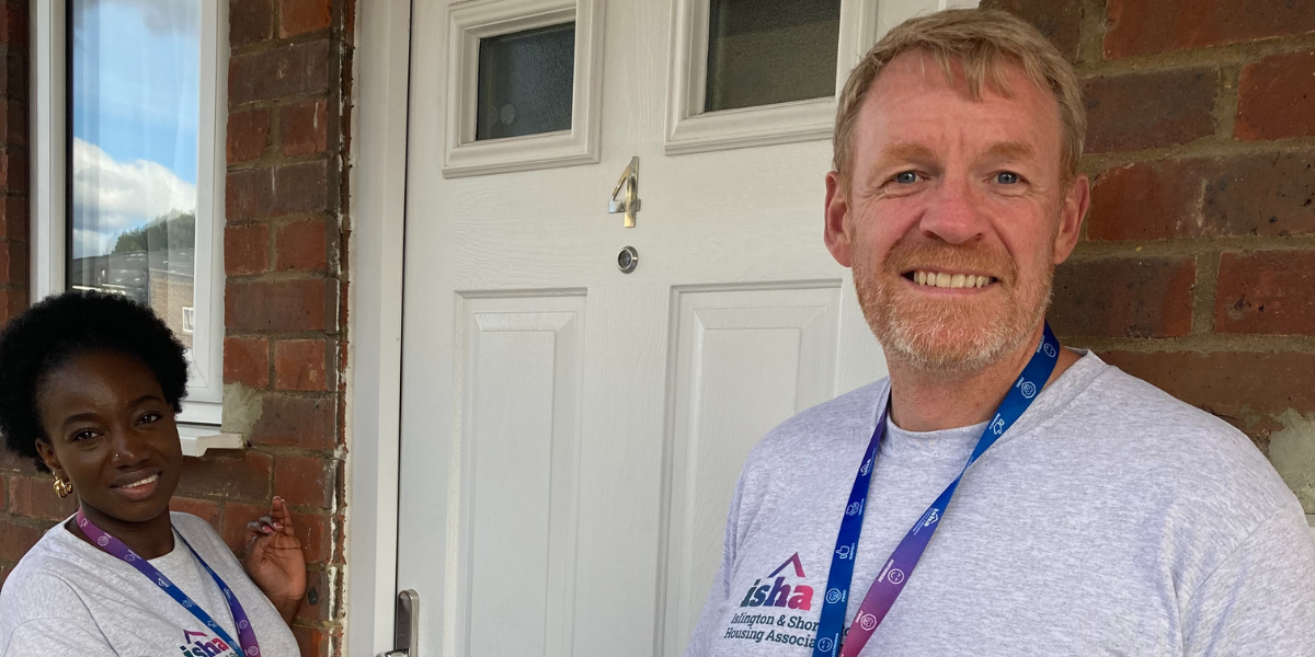 Two ISHA staff members knocking on a residents door. 
