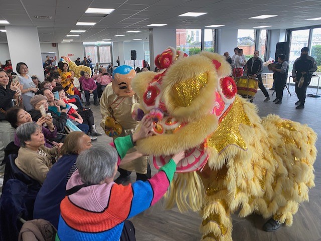 A traditional dragon dance performer engages with the audience at a Lunar New Year celebration in 2026.