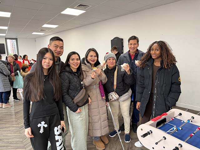 Outreach and Support Officer Chuong with attendees at a Lunar New Year celebration in 2026.