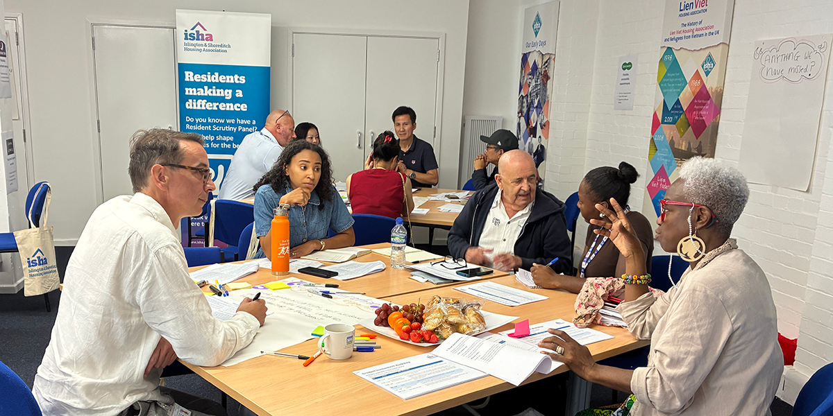 ISHA staff and residents discussing our repairs service during a workshop.
