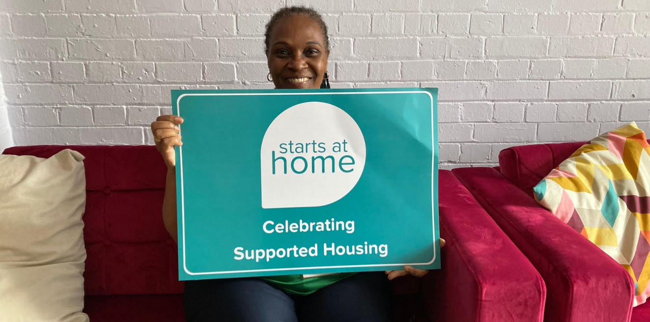 ISHA staff holding banners promoting supported housing.